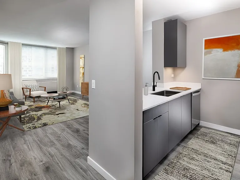 Renovated Package II kitchen, living, and dining areas with hard surface plank flooring