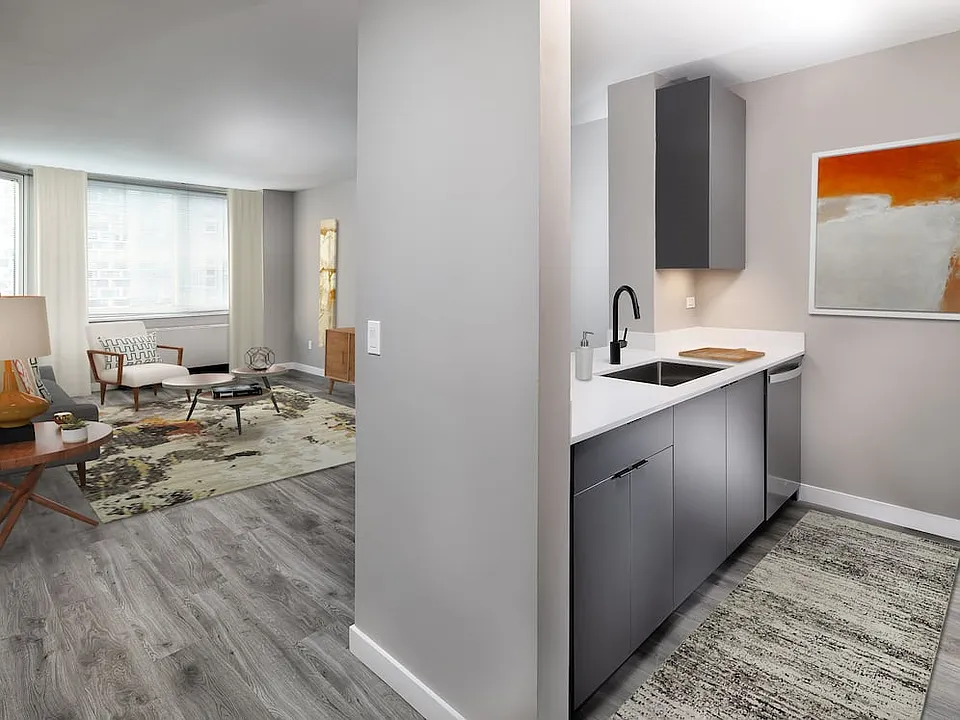 Renovated Package II kitchen, living, and dining areas with hard surface plank flooring