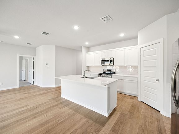 Kitchen in the Emmy II home plan by Trophy Signature Homes - REPRESENTATIVE PHOTO