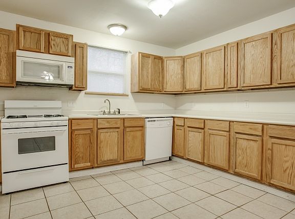 Kitchen area showing Gas stove, microwave and dishwasher.