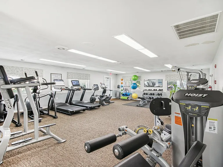 a view of our gym with various machines and weights