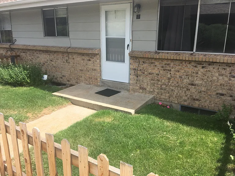 front door to unit with private yard
