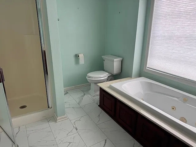 MBR Bathroom with shower and tub.