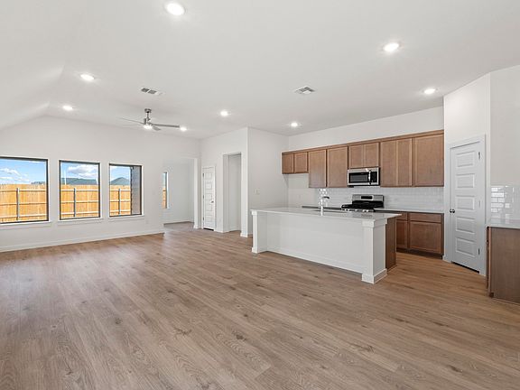 Kitchen in the Quartz home plan by Trophy Signature Homes - REPRESENTATIVE PHOTO