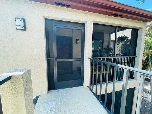 Screen door entrance and patio exterior view.