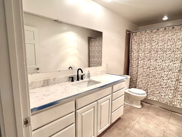 Basement bathroom (was in the process of cabinets being painted when picture taken; ignore blue paint tape).