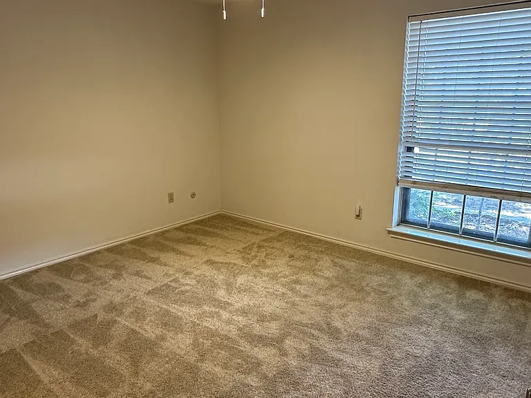 Bedroom with carpeted floors, a ceiling fan
