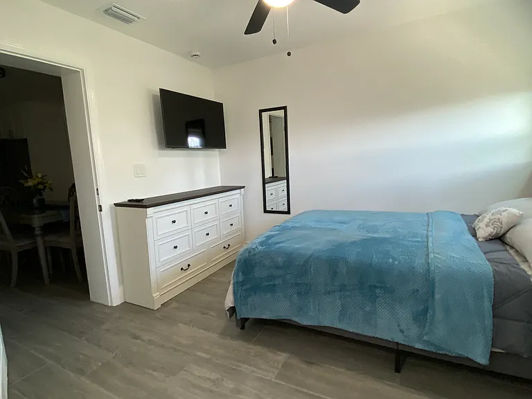 A Smart TV with elegantly designed cabinetry and under bed storage.