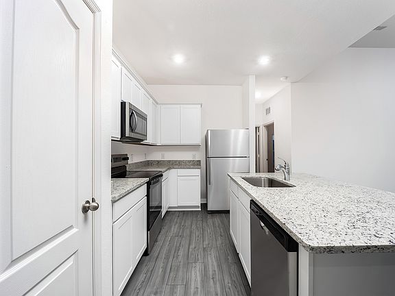 Stainless steel appliances and granite countertops in the kitchen