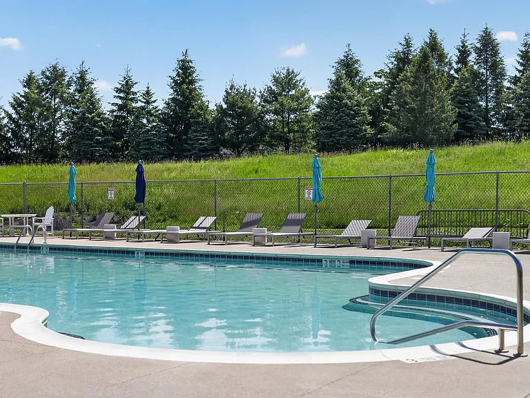 Relax by the sparkling pool at Lake Shore Park Apartments, where lush greenery creates a tranquil escape. Enjoy sun-soaked days and refreshing swimsyour oasis awaits. Schedule a visit today!
