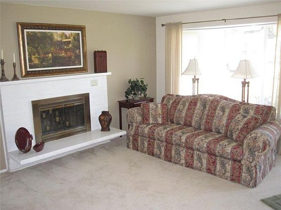 Family room with wood burning fireplace.