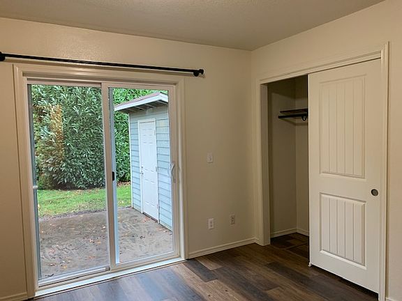Closet in the main bedroom, standard size, double sliding doors. Sliding glass door in the main bedroom leads out to the back patio.