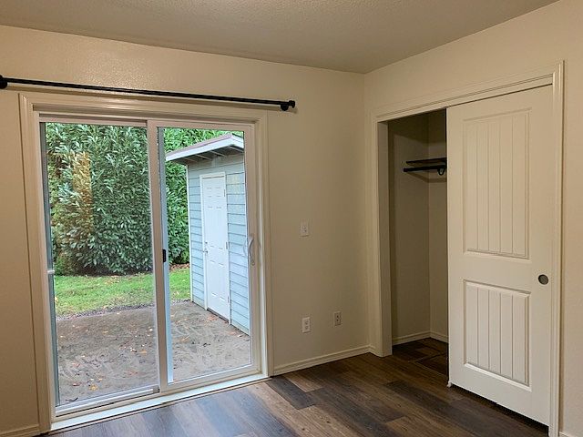 Closet in the main bedroom, standard size, double sliding doors. Sliding glass door in the main bedroom leads out to the back patio.