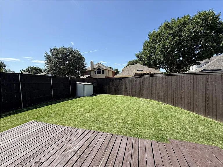 BACK YARD WITH LARGE DECK, NEWER PRIVACY FENCE AND ROOM LEFT FOR PLAY AREA.