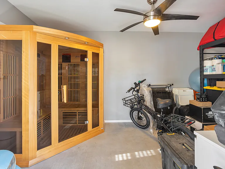 Three-person infrared sauna housed in a modern, climate-controlled shed with concrete floors and ample storage