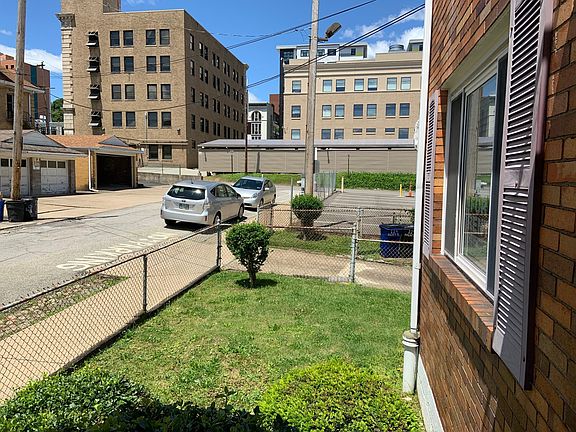 View of Pitt Police building from front porch of duplex. Note that Halket Place is not a through street but ends behind this building.