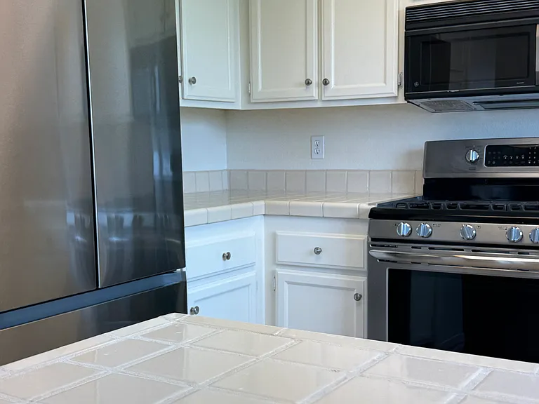 Kitchen with Roomy Stainless Counter Depth Fridge with Ice Maker.