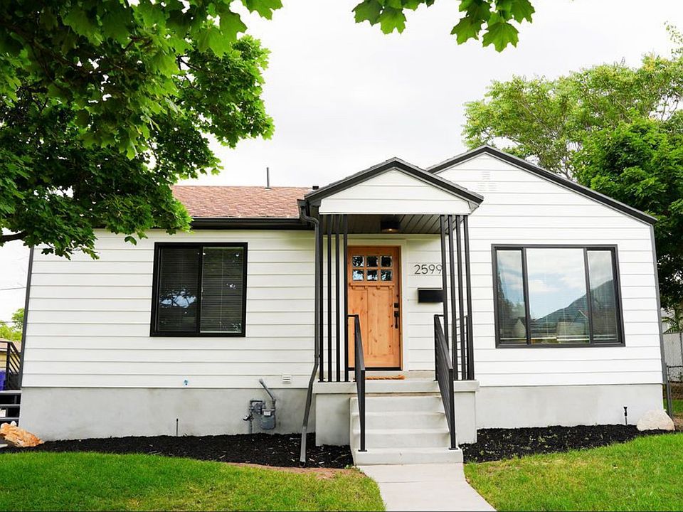 Front entrance and exterior of the home. New porch, railing and front door.