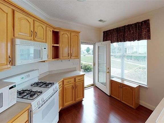 14x11 Kitchen with gas stove, microwave oven, dishwasher, refrigerator and laminate flooring