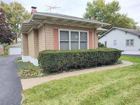 Driveway with view of garage