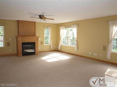 large 21' x 18' living room with gas log fireplace