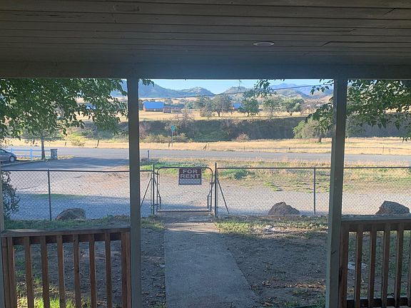 Out living room window view of mountains and old barn
