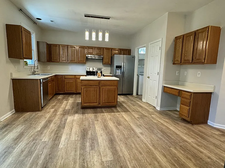Lovely kitchen with island and room for a table.