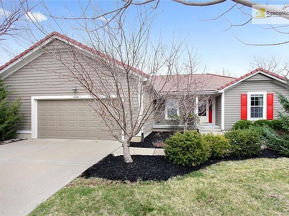 Beautiful landscaping surrounds the entire home.  Notice the upgraded roof and expanded garage!