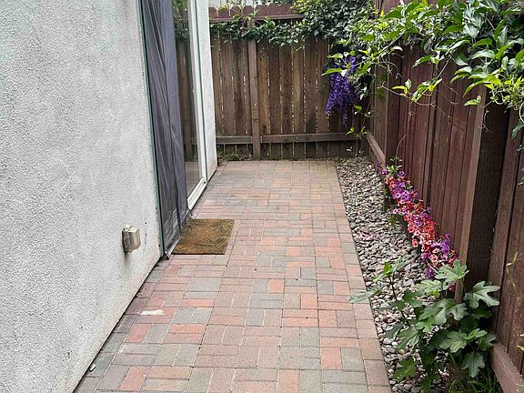 Entry paver patio. Sliding glass door with walk-through magnetic closing screen.