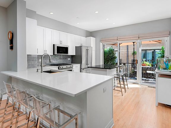 This kitchen has two islands, both which seat 4 pe