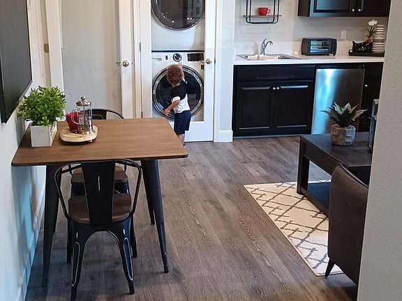 Example of furnished living and eating rea, with built in laundry in unit.