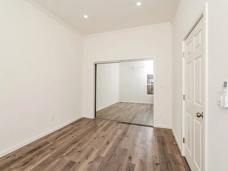 Primary bedroom with mirrored closet doors