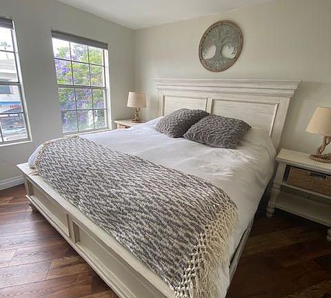 First Master Bedroom has two separate closet spaces. It accommodates a California King Bed with bed side tables.