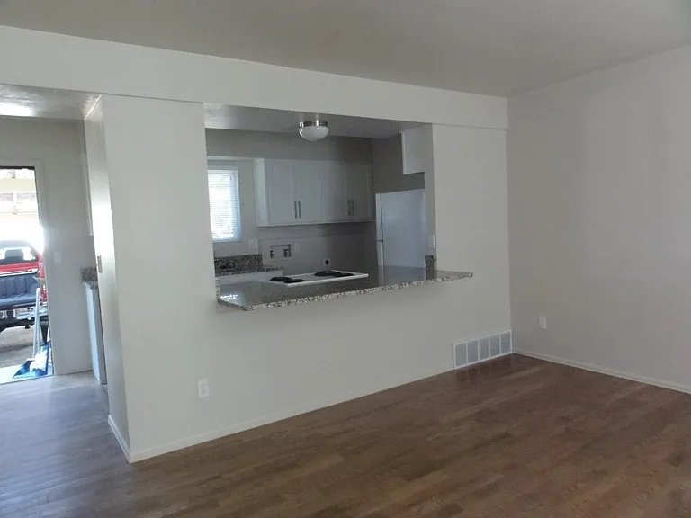Living room, kitchen, L shaped dining area.