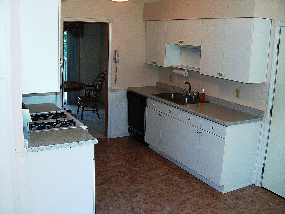 Kitchen offers with new flooring offers a charming breakfast nook.