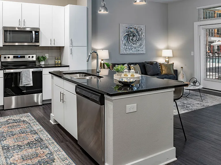 Experience the charm of this contemporary kitchen seamlessly connecting to a stylish living area.