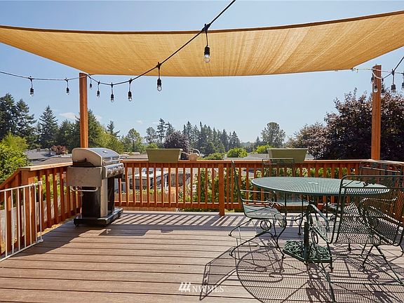 The deck is right off the kitchen and there is even a peak view (around a tree) of Mount Rainier when it out