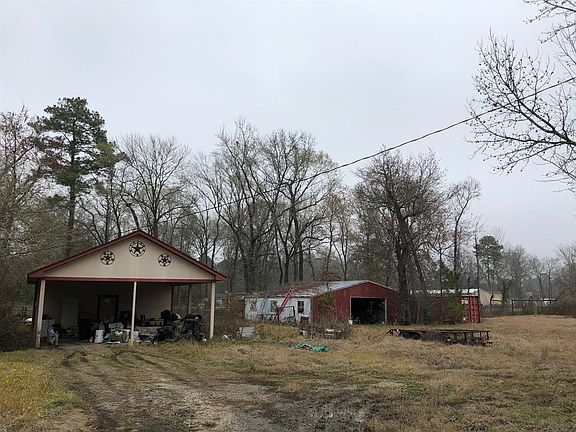 Featuring an over-sized carport with loads of storage, a 6-stall barn, a work-shop behind it, and a large shipping container for all of your toys, all on just over an acre of land, this has potential written all over it!