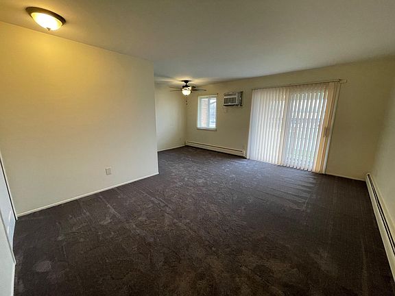 Large open living room and eating area features a doorwall leading to your own personal balcony.