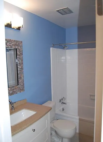 Full bathroom second floor with bathtub and shower.
