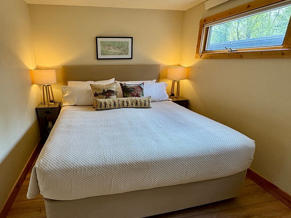 King bed with soft linens, lots of blankets and pillows