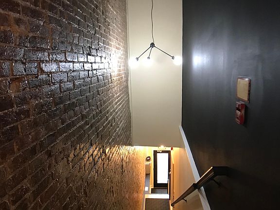 Common area has beautiful original exposed brick