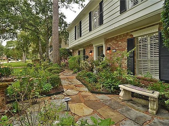 Flagstone walkway borders the front flower beds for easy access to the driveway.