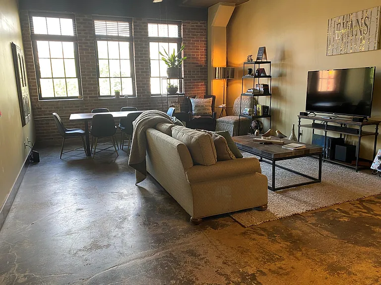 Very spacious living room with large windows.