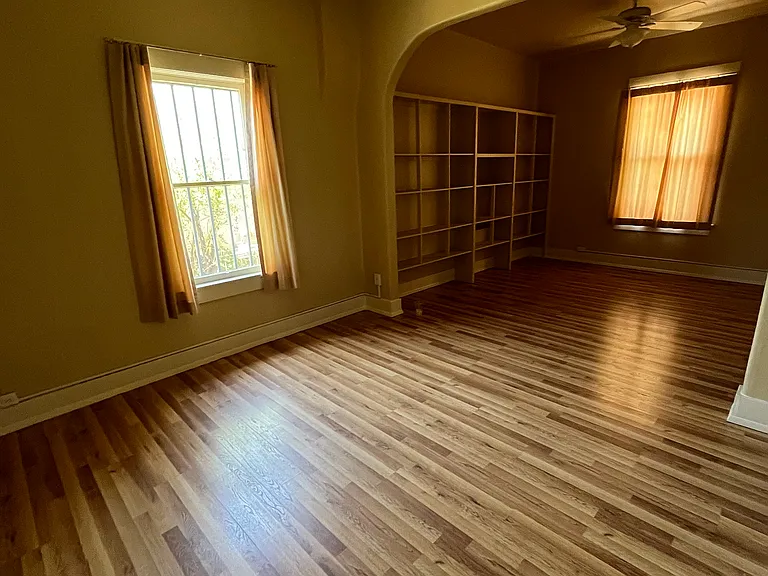 Open floor plan with living room with built-in bookcases and dining room.