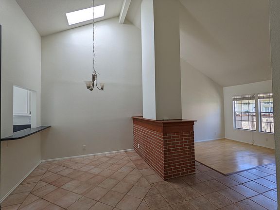 Living Room and Dining Room. Cathedral ceilings and skylight provide a lot of natural light.