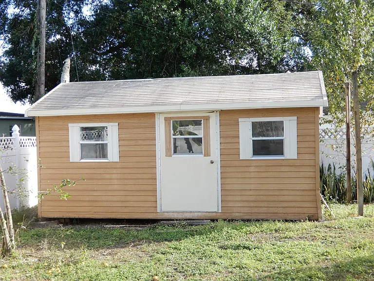 Out building that is insulated and has a built in A/C unit. Great hobby shop, office or get away place.