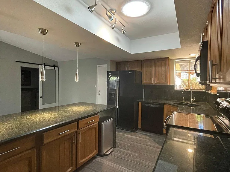 Black appliances and granite countertops.