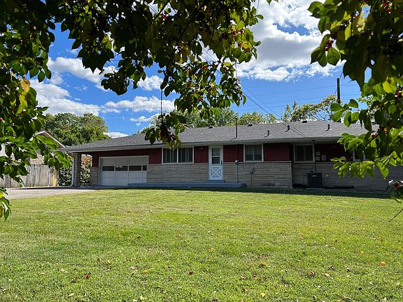 The back side view of the house with 2 cars garage