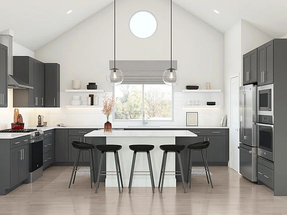 Kitchen with vaulted ceiling and pendant lighting